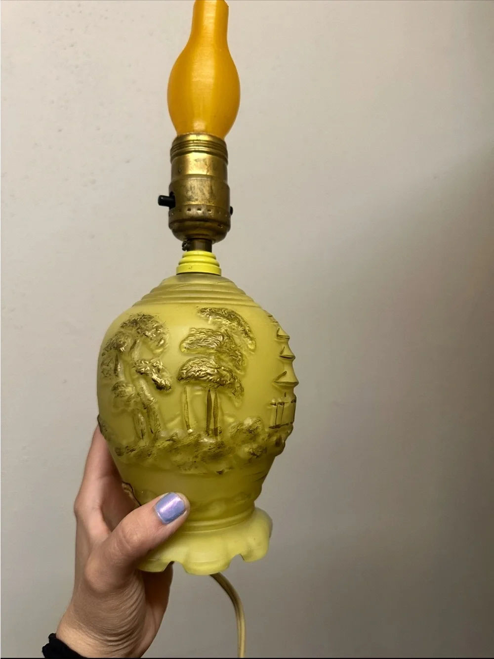 Vintage yellow molded glass table lamp features an embossed Asian landscape